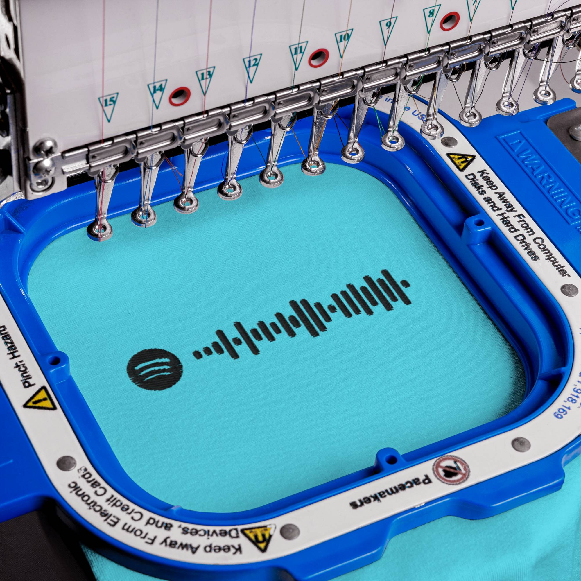 Turquoise Tshirt with embroidered custom music code